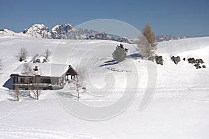 a house covered by snow in the high mountains