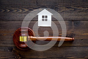 House cutout near judge gavel on dark wooden background top view copy space. Housing law. Property division. Real estate