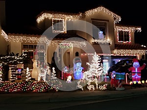 Illuminated Holiday Cheer: Rancho Cucamonga House Decorated with Christmas Lights at Night.