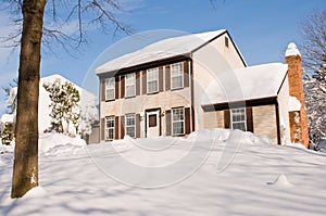 House in deep winter snow