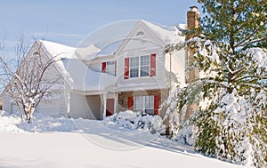 House in deep winter snow