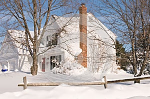 House in deep winter snow