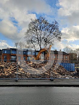 House demolition using an excavator. Bulldozer crushing an old building