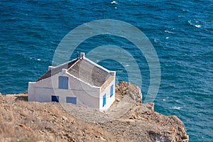 House on the edge of a cliff overlooking the sea