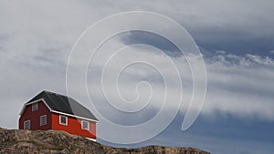 a house on the edge of the mountain under the cloudy sky, Sisimut, Greenland