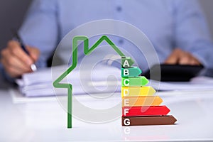 House With Energy Efficiency Rate On Desk