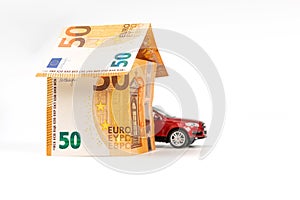 House from euro banknotes and car, isolated. loan, real estate and car insurance concept