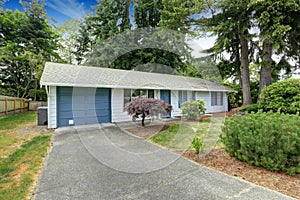 House exterior with blue trim. Garage with driveway