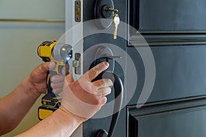 house exterior door with the inside internal parts of the lock visible of a professional locksmith installing or repairing a new d photo