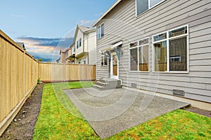 House exterior with mocha siding. View of patio area with concrete floor.