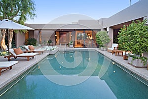 House exterior with pool at dusk