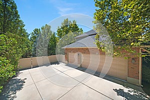 House exterior with three-car garage on the backyard with fence and gate