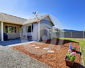 House exterior. Walkout deck with sawdust and flowers photo