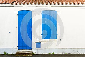 House facade with blue blinds and door