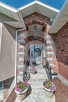 House facade with blue glass planed front door at the cozy gabled portico