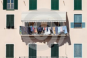 House facade with clothes hanging out to dry. Italian culture.