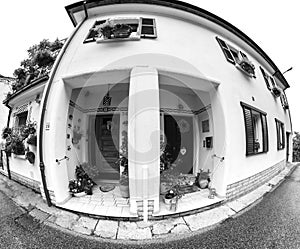 House facade with flowers. Fish eye.