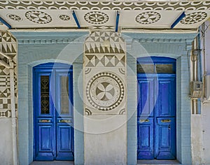House facade in Pyrgi village with traditional geometrical shapes decoration on wall and balcony