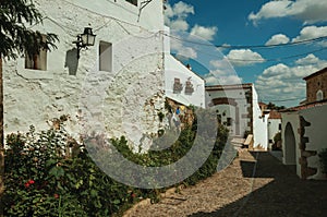 House facade with white walls, stairs, flower pots and plants at Caceres