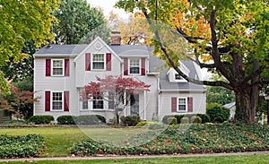 House in Fall with Red Shutters