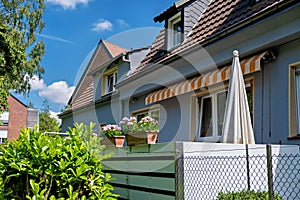 House with fence and white umbrella in Germany