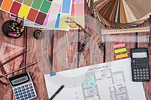 House floor paper plan and wooden sampler, work tolls, calculator