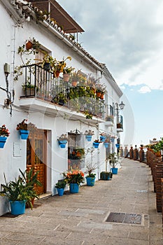 House with flowers in blue pots in Mijas, Spain