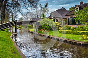 House and flowery courtyard on the waterfront, Giethoorn village, Netherlands