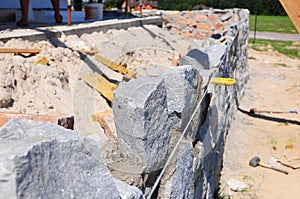 House foundation wall construction from rock and concrete