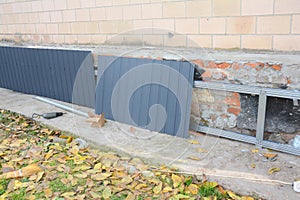House foundation wall repair,  renovation  with installing metal sheets on metal frame for waterproofing and protect from wetness photo