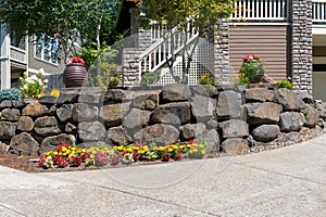 House Front Yard Landscaping with Rock Retaining Wall photo