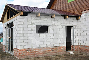 House garage under construction. Building construction new house garage from aerated concrete blocks with metal roof