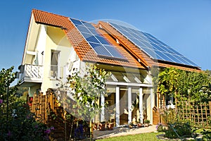 House with garden and solar panels photo