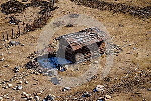 House with glacial traces on yellow stone ground at Thangu and Chopta valley in winter in Lachen. North Sikkim, India