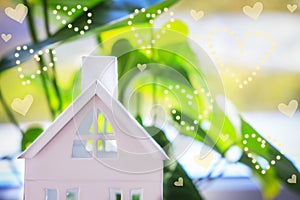 House on green background with heat bokeh. Home insurance concept