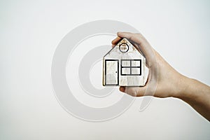 House in hands. Real estate, rent, purchase, sale, insurance concept. Model of a wooden house in the hands of the owner