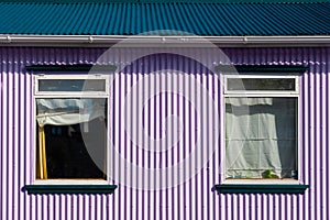 The house has a blue roof and purple walls photo