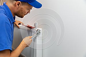 House heating system installation plumber installing radiator