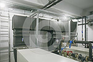 House heating system with many pipes, metal tubes and automated control equipment