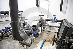 House heating system with many steel and plastic pipes, metal tubes and automated control equipment