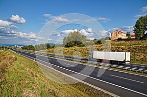 House of highway in a rural landscape, truck on the road