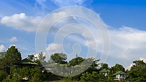 A house on a hill under cloudy movement