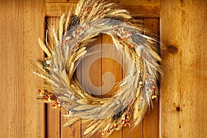 House home front door Fall autumn Thanksgiving decorations country style natural botanical rustic wreath on wood background