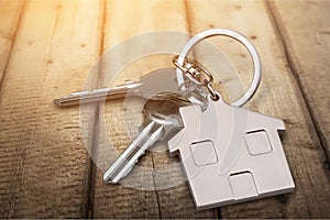 House keys with house figure on background photo