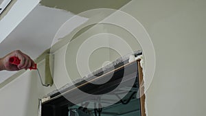 House improvement and renovation concept. Male house painter hand painting wall with roller. Anonymous painter man at