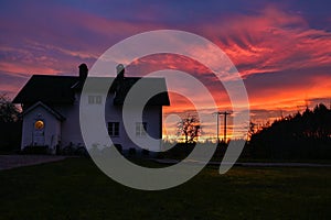 house infront of colorful evening sky in orange