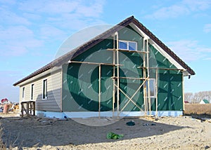 House insulation with installing siding. Plastic siding and insulation membrane on house