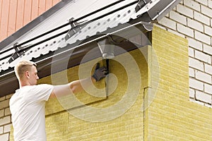 House insulation - insulating house facade with mineral woo photo