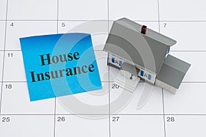 House Insurance due with house and sticky note on a calendar