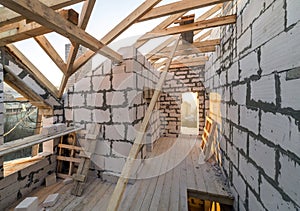 House interior under construction and renovation. Energy saving walls of hollow foam insulation blocks and bricks, ceiling beams